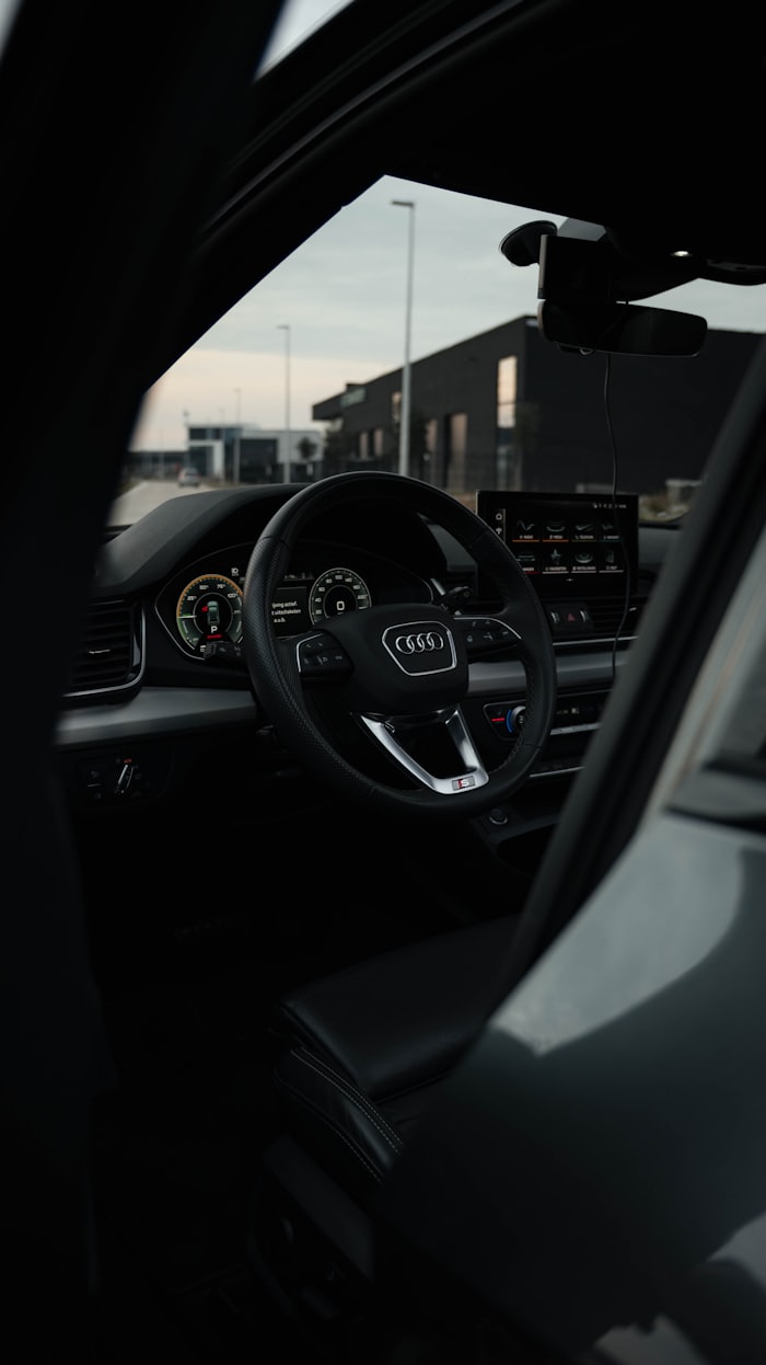 Interior of a modern car showing the steering wheel and instrument display